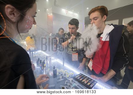 Moscow, Russia - December 9, 2016: People attend Vapexpo Moscow 2016 exhibition which presents new modern vape gadgets, liquids and flawours
