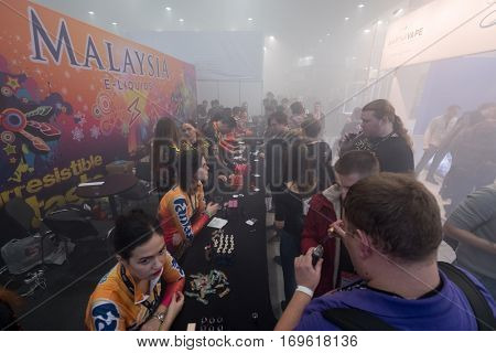 Moscow, Russia - December 9, 2016: People attend Vapexpo Moscow 2016 exhibition which presents new modern vape gadgets, liquids and flawours
