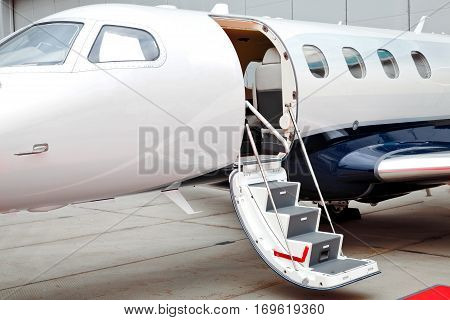 Ladder with open door in business jet airplane