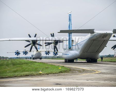 Kiev Region Ukraine - September 25 2008: Antonov An-22 turboprop cargo plane on the taxiway and Antonov An-70 on the background