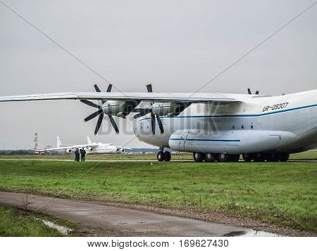 Kiev Region Ukraine - September 25 2008: Antonov An-22 turboprop cargo plane on the taxiway and Antonov An-225 Mriya on the background