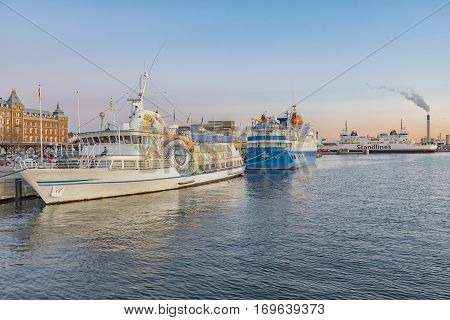 HELSINGBORG SWEDEN - FEBRUARY 16 2016: The sun sets in the harbour at Helsingborg in Sweden.