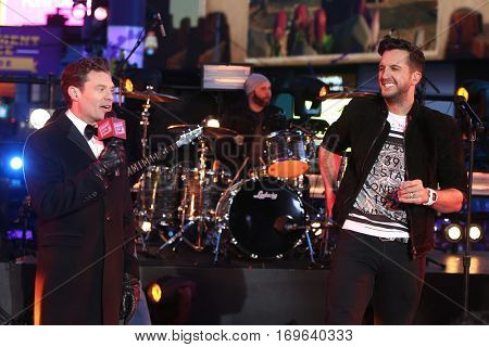 NEW YORK-DEC 31: Recording artist Luke Bryan (R) and Ryan Seacrest onstage during Dick Clark's New Year's Rockin' Eve at Times Square on December 31, 2015 in New York City.