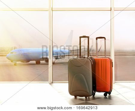 Suitcases at airport near window. Traveling concept