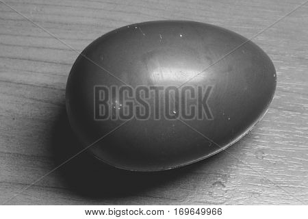 chocolate egg on a wooden table background.