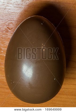 chocolate egg on a wooden table background.