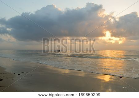 Dhow on the ocean at sunrise on Bamburi beach in Kenya