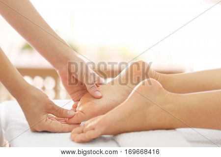 Foot massage in spa salon, closeup