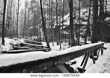 Snowy Wooden Railing At Entrance To Peklo Valley In Machuv Kraj Region In Czech Republic