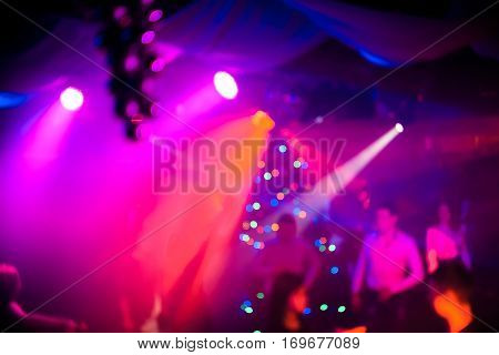 background in a night club atmosphere with people and lasers at the party
