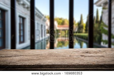 Wood Table Top On Blur Pool With Home Wall And Garden Background In Morning.for Montage Product Disp