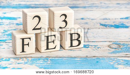 February 23Th. Wooden Cubes With Date Of 23 February On Old Blue Wooden Background.