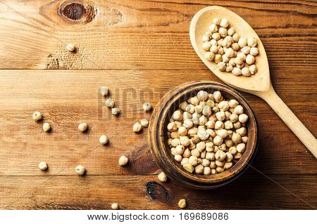 Portion of Chick Peas in wooden bowl with spoon top view