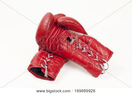 old used red leather boxing gloves concept putting hands together isolated on white background