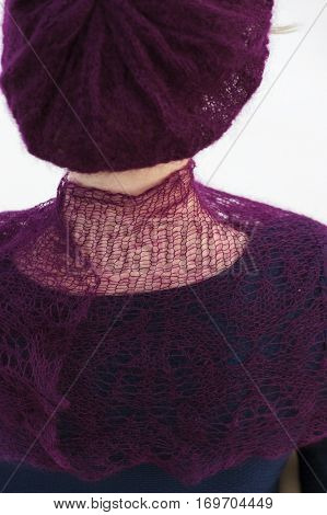Unrecognizable model in knitted crochet scarf beret. Closeup back view 