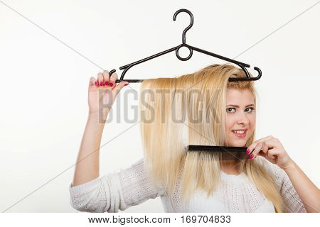 Blonde Woman Holding Hair On Clothes Hanger