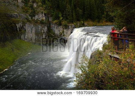 Mesa Falls Water Falls and Flowing River in Cayon Lush Green Foliage Powerful Water Kids Looking