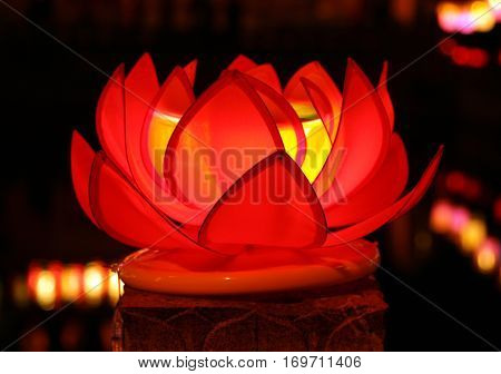 Beautiful red lotus with candle inside - traditional decoration of chinese buddhist temple symbol of purity