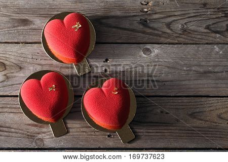 Red heart cacke desserts on wooden background. dessert for breakfast on Valentine's Day.