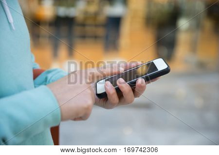 hands use smartphone taking photo front of shopwindow