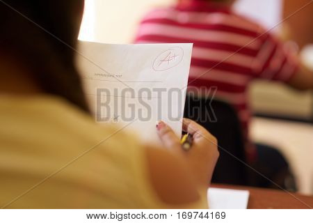 Young people and education. Group of hispanic students in class at school during lesson. Good grade for smart student on test