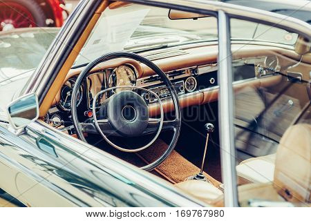 luxury car interior, leather steering wheel front seats and dashboard panel