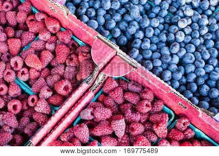 Raspberry And Blueberry Sold In Boxes On A Farmers Market
