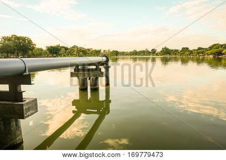 Steel pipe connect from pump into the lake within public park