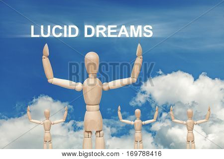 Wooden dummy puppet on sky background with words LUCID DREAMS. Abstract conceptual image