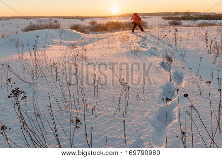 photographer takes winter landscape at dawn in the bitter cold.