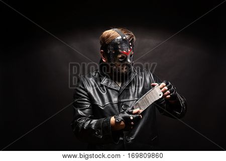 Bloody murderer in hockey mask with meat cleaver