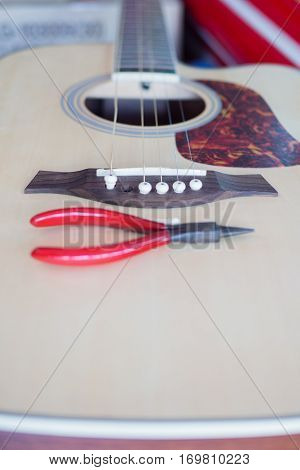Put the pins and string to acoustic guitar