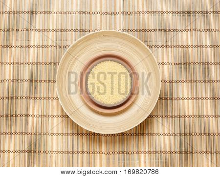 Plate with bath salt on bamboo mat. Health, treatment, spa concept.