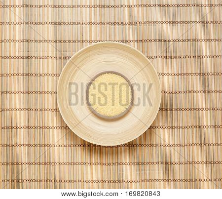 Plate with bath salt on bamboo mat. Health, treatment, spa concept.