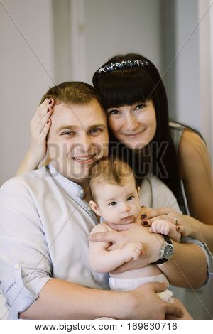 happy family consisting of mom and dad's baby boy. happy family relationships. mother entertains a child, his father holding him in his arms.