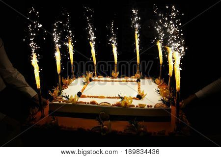 Rectangular Birthday fruit cake with fireworks candles