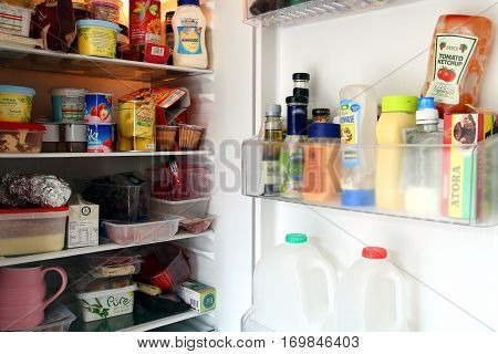 Camberley, UK - Feb 1st 2017: Contents of a packed domestic UK fridge or refrigerator full of British supermarket food from England