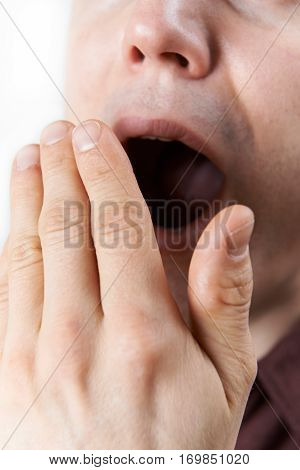 Studio Close Up Of Young Man Yawning