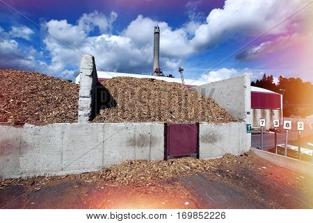 Bio Power Plant With Storage Of Wooden Fuel Against Blue Sky