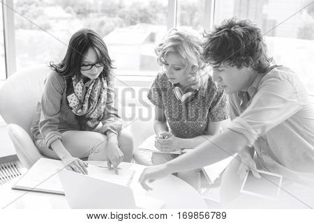 Creative businesspeople discussing at table in creative office