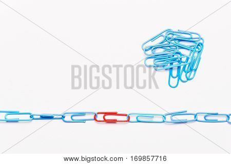 Undaunted red paperclip. Miscellaneous office supplies. Assortment of stationery.