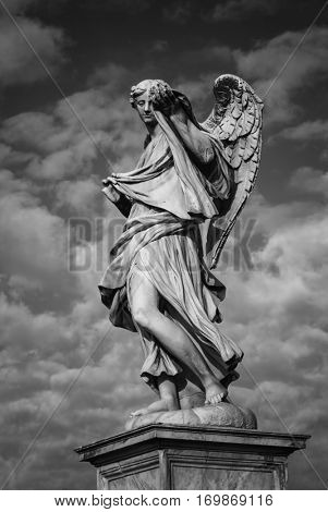 Statue of an angel standing on the bridge leading to the Castle Sant'Angelo, Rome. Angel with the Sudarium. designed by Bernini for Pope Clement IX.