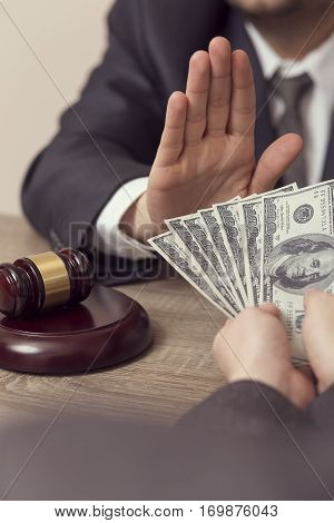 Detail of a judge refusing a bribery money. Selective focus