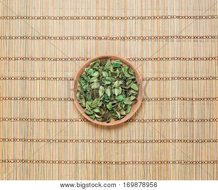 Plate with aroma petals on bamboo mat. Spa, beauty, treatment concept. 