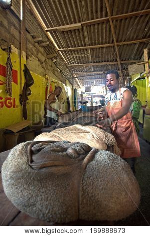 Akra Ghana - January 4 2014: Man sells cow's intestines on the market