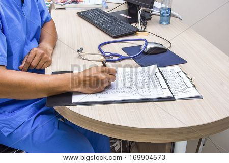 doctor write order note stetchoscope and keyboard on the desk in office