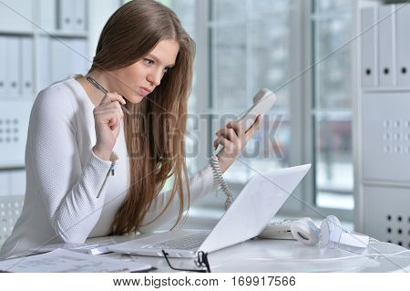 young woman working at office using laptop