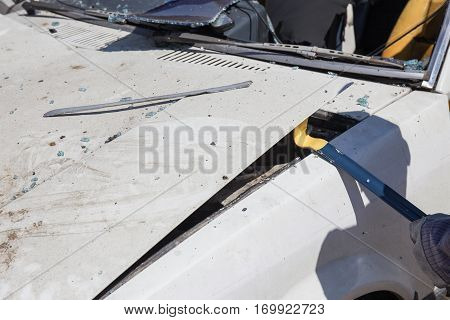 forensic hand in glove lift car bonnet by crowbar to search evidence from car bomb in crime scene investigation training