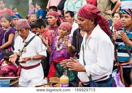 TIKAL, GUATEMALA - DEC 21, 2015: Unidentified Mayan people and tourists surround a fire on December 21, 2015  in Tikal, Guatemala. Traditional Mayan fire ceremony at the 2015 new year celebrations.