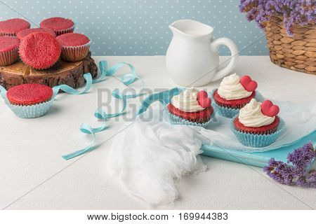 Red velvet heart cupcakes with cream cheese frosting and a red heart for Valentine's Day